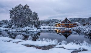 winter in Tasmania - cosy warm lodge by a winter lake